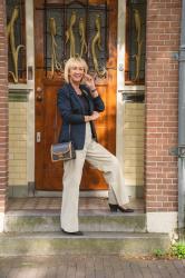 Pebble coloured trousers with a blue blazer and a blue blouse