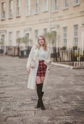 A Tartan Skirt With A Long White Coat Outfit
