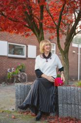 Pleated skirt and the Angela Caputi padlock necklace