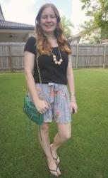 Black Tees and Printed Culotte Shorts With Green Mini 5-Zip Bag