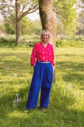 Bright blue trousers with a bright pink blouse