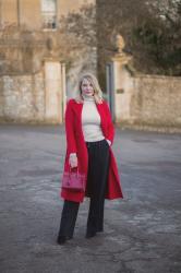 A Red Coat With Wide Leg Trousers