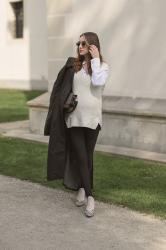Black trench coat, heel-strap leggings, and zebra mules